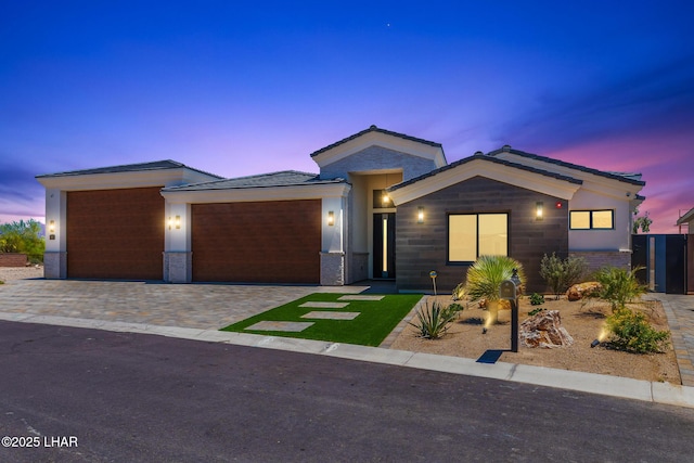 816 Isola Bella Loop, Lake Havasu City, AZ 86403 - view of front of house featuring an attached garage, decorative driveway, and brick siding