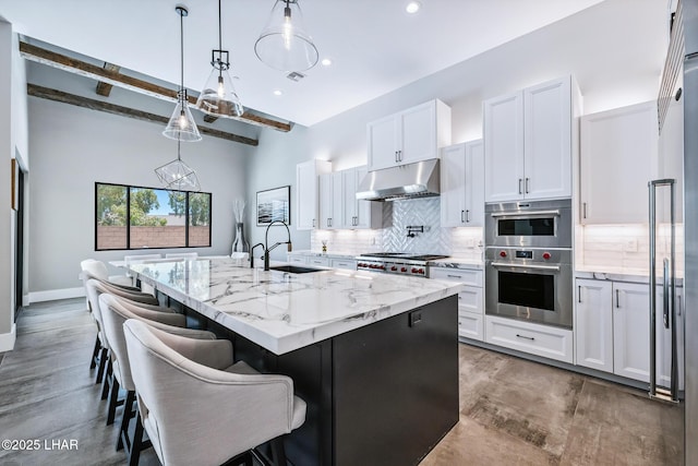 816 Isola Bella Loop, Lake Havasu City, AZ 86403 - kitchen with under cabinet range hood, stainless steel appliances, wood finished floors, tasteful backsplash, and recessed lighting