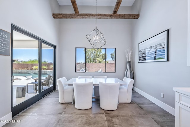 816 Isola Bella Loop, Lake Havasu City, AZ 86403 - dining room featuring a chandelier, concrete floors, beam ceiling, and a high ceiling