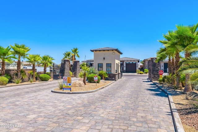816 Isola Bella Loop, Lake Havasu City, AZ 86403 - mediterranean / spanish home with a tiled roof, stucco siding, a gate, driveway, and a garage