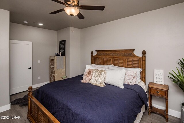 bedroom featuring hardwood / wood-style flooring and ceiling fan