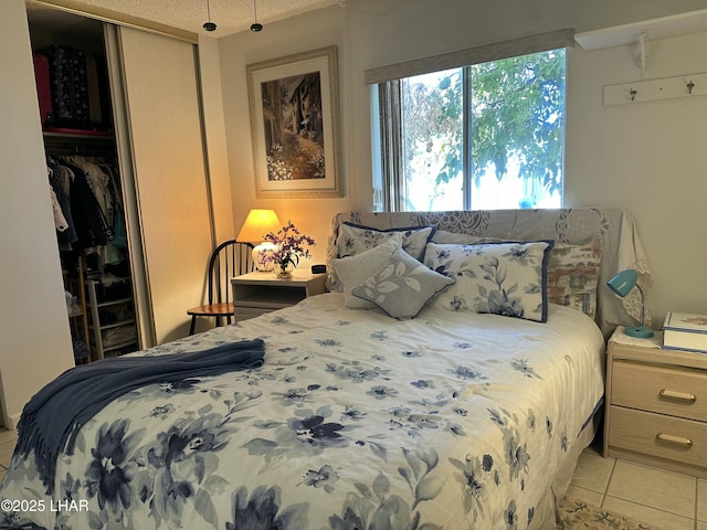 bedroom featuring light tile patterned floors and a closet