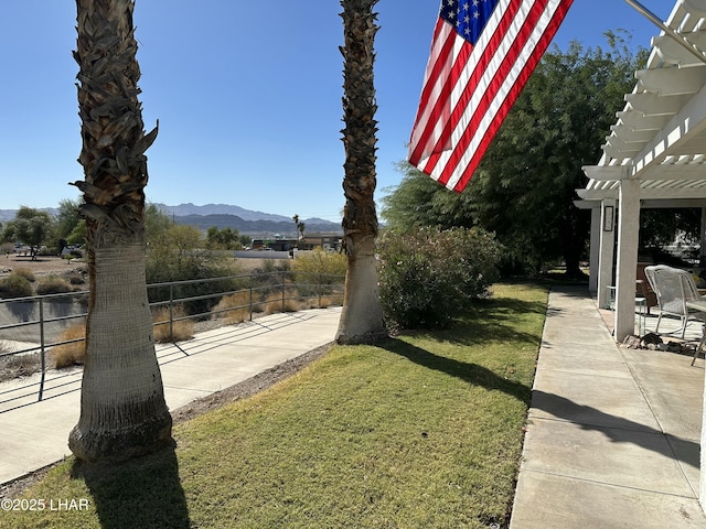 view of yard with a mountain view, a pergola, and a patio area