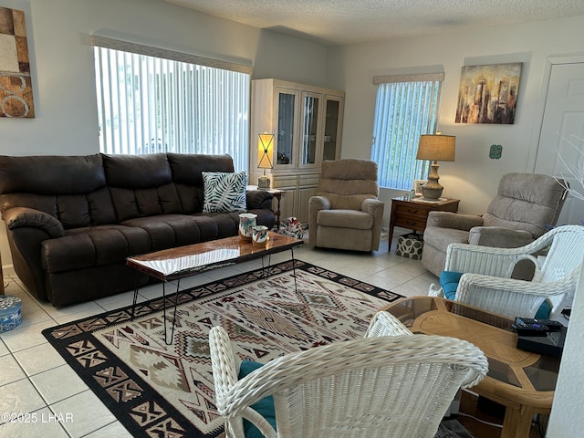 living room with light tile patterned floors and a textured ceiling