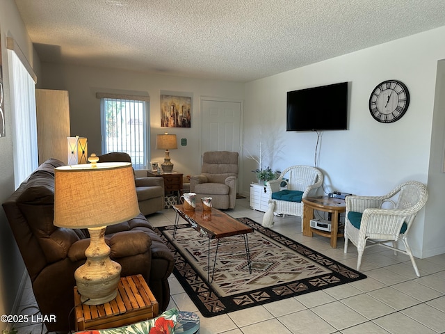 living room with light tile patterned flooring and a textured ceiling