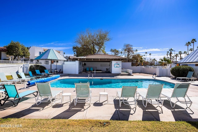 pool with fence, a gazebo, and a patio