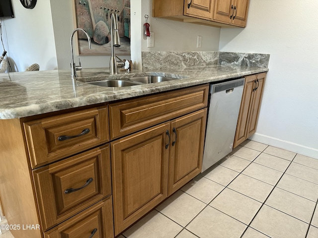 kitchen with stone countertops, dishwasher, light tile patterned floors, sink, and kitchen peninsula