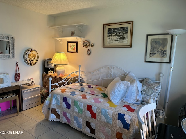 bedroom with a textured ceiling and light tile patterned floors