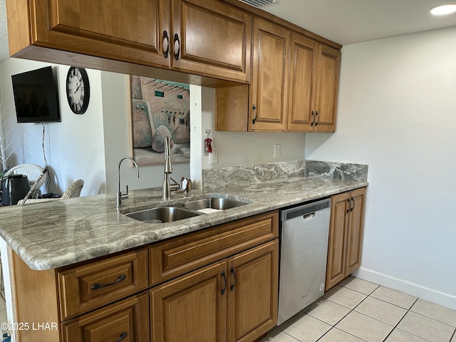 kitchen with kitchen peninsula, light stone countertops, sink, dishwasher, and light tile patterned floors