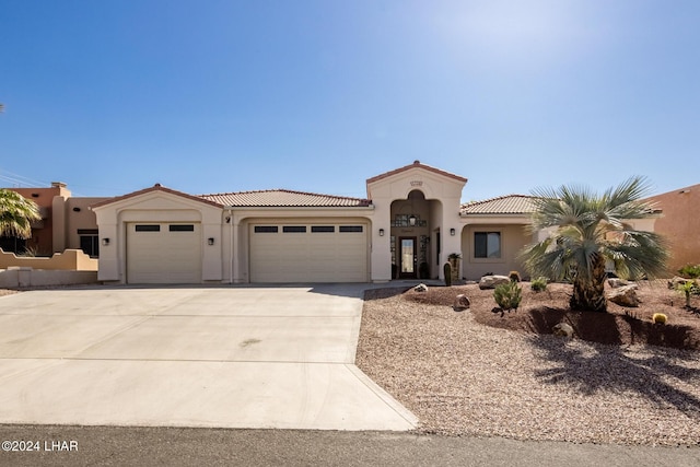 mediterranean / spanish house featuring a garage