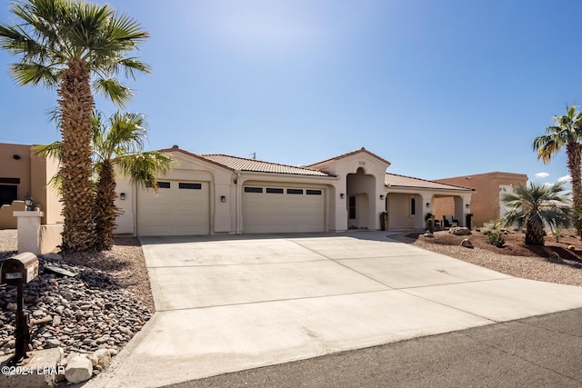 mediterranean / spanish-style house with a garage