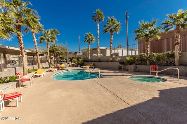 view of pool with a community hot tub, a pergola, and a patio