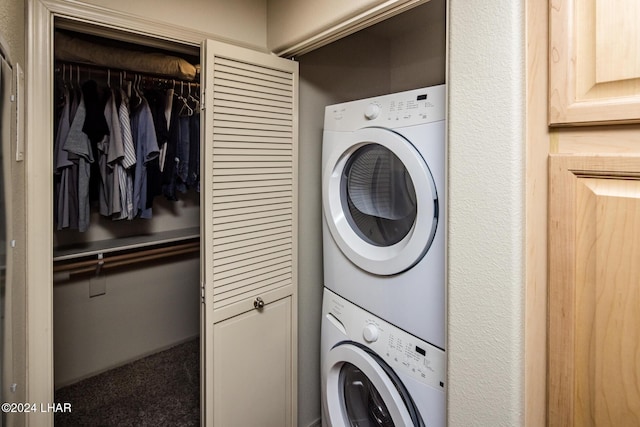 laundry area featuring stacked washer / drying machine