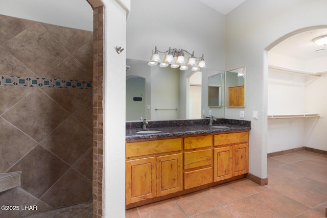 2624 Rainbow Ave N, Lake Havasu City, AZ 86403 - bathroom featuring a sink, tiled shower, double vanity, and tile patterned floors