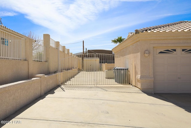 2624 Rainbow Ave N, Lake Havasu City, AZ 86403 - view of patio featuring fence, a garage, and a gate