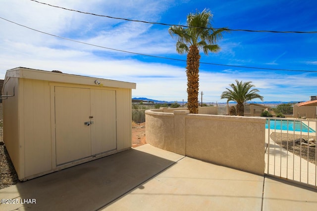 2624 Rainbow Ave N, Lake Havasu City, AZ 86403 - view of patio / terrace featuring an outbuilding, a storage unit, and fence
