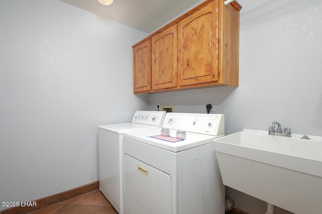 2624 Rainbow Ave N, Lake Havasu City, AZ 86403 - clothes washing area with independent washer and dryer, a sink, cabinet space, light tile patterned floors, and baseboards