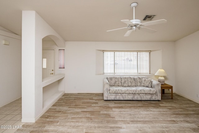 unfurnished room featuring lofted ceiling, ceiling fan, and light wood-type flooring