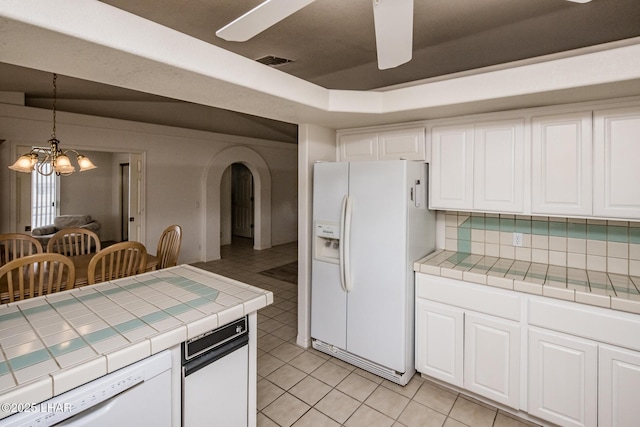 kitchen with white cabinetry, tile counters, and white appliances