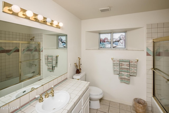 full bathroom with tile patterned floors, vanity, toilet, and enclosed tub / shower combo