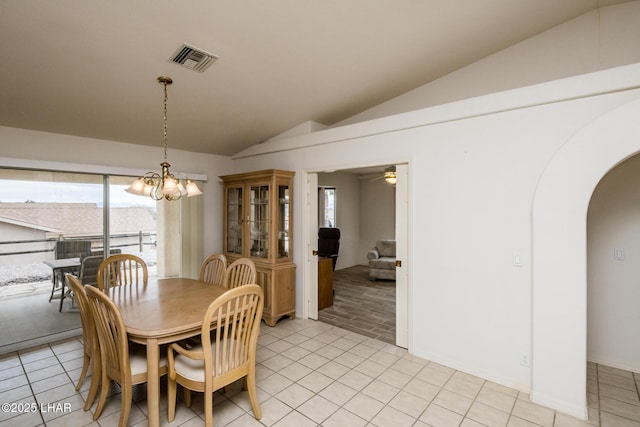 dining space featuring lofted ceiling, plenty of natural light, and light tile patterned flooring