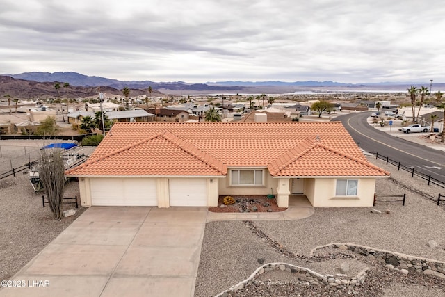 view of front of home featuring a garage and a mountain view