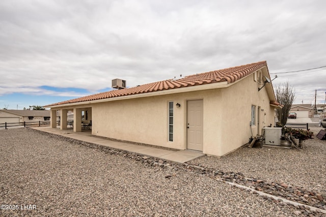 back of property with a patio and central air condition unit