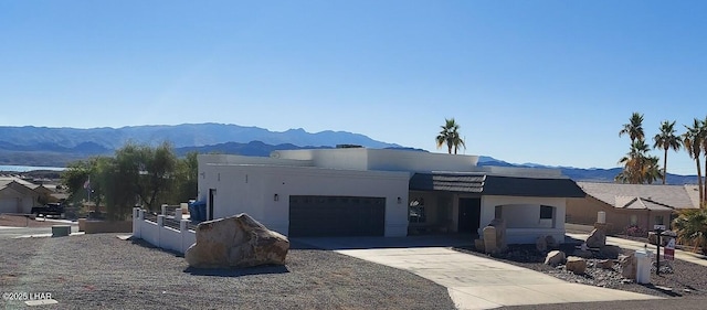 view of front of home with a mountain view and a garage