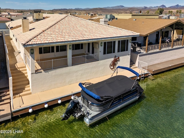 8731 Yaqui, Parker, AZ 85344 - back of house featuring stucco siding, a tile roof, a mountain view, and a chimney