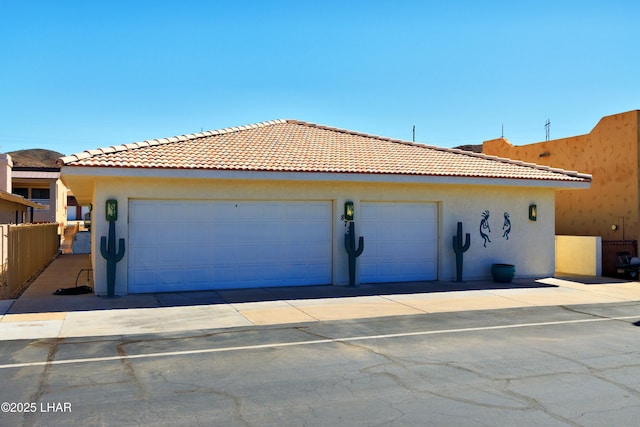 8731 Yaqui, Parker, AZ 85344 - view of front of house with a tile roof, stucco siding, fence, and driveway
