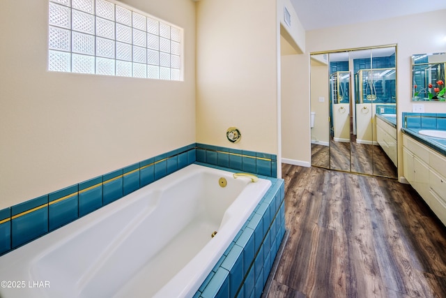 8731 Yaqui, Parker, AZ 85344 - full bathroom featuring vanity, a bath, baseboards, visible vents, and wood finished floors
