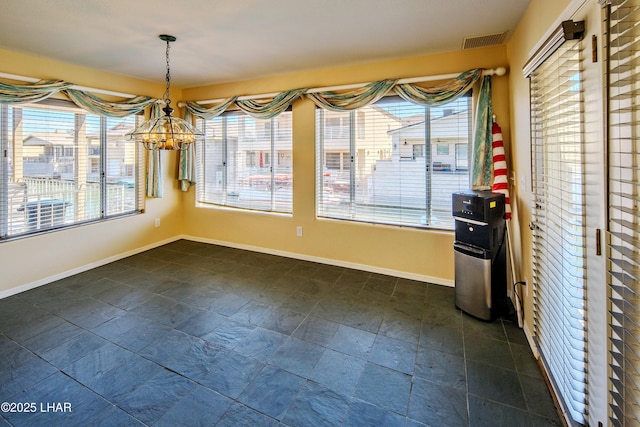 8731 Yaqui, Parker, AZ 85344 - unfurnished dining area with an inviting chandelier, baseboards, and visible vents