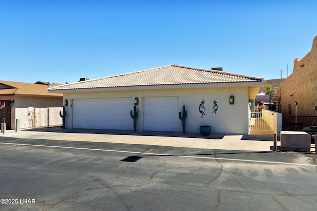 8731 Yaqui, Parker, AZ 85344 - view of property exterior featuring a tiled roof, a gate, stucco siding, and fence