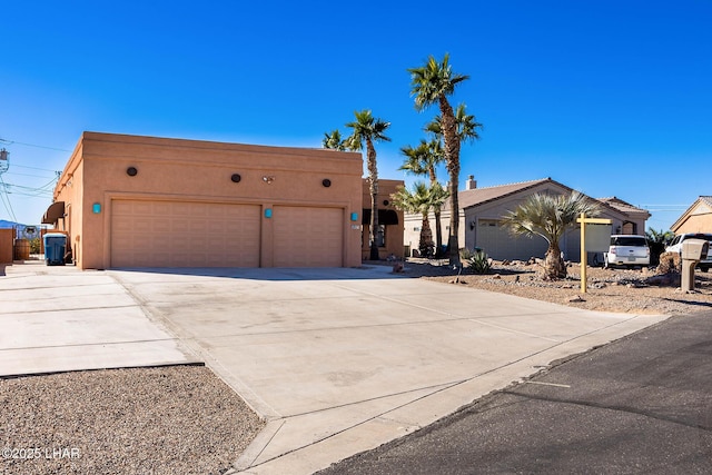 875 Wallingford Pl, Lake Havasu City, AZ 86406 - view of front of property featuring stucco siding, driveway, and an attached garage