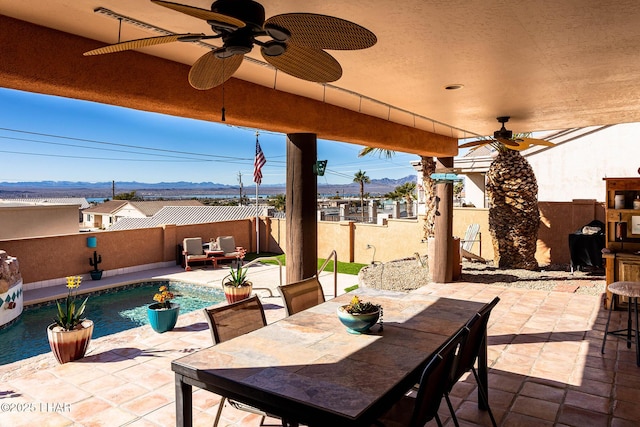 875 Wallingford Pl, Lake Havasu City, AZ 86406 - fenced backyard featuring a mountain view, ceiling fan, a patio, and outdoor dining area