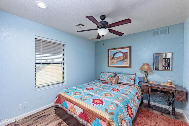 875 Wallingford Pl, Lake Havasu City, AZ 86406 - bedroom with wood finished floors, a textured wall, a textured ceiling, and a ceiling fan