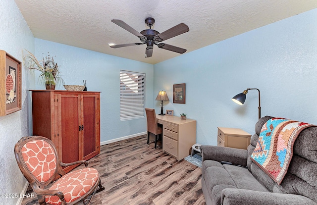 875 Wallingford Pl, Lake Havasu City, AZ 86406 - home office with a textured wall, light wood-style floors, a ceiling fan, and a textured ceiling