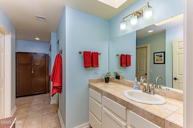 875 Wallingford Pl, Lake Havasu City, AZ 86406 - bathroom with vanity, a skylight, tile patterned floors, and recessed lighting