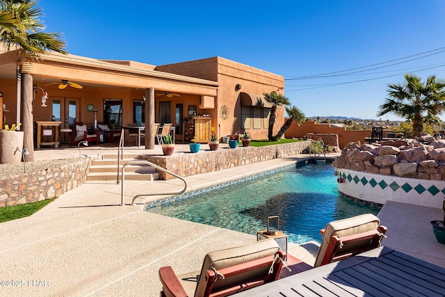 view of pool with french doors, a patio, and ceiling fan