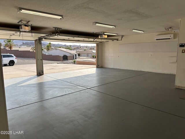 875 Wallingford Pl, Lake Havasu City, AZ 86406 - garage with an AC wall unit and a garage door opener