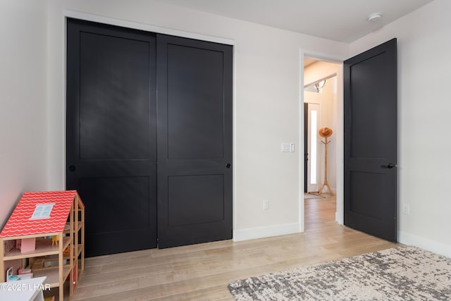 bedroom featuring a closet and light hardwood / wood-style flooring