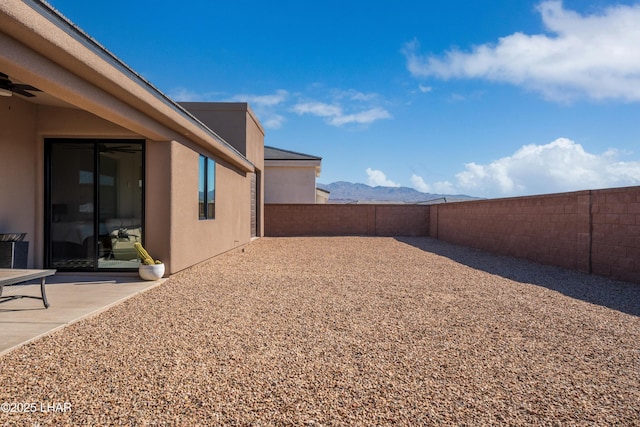 view of yard featuring a mountain view and a patio area