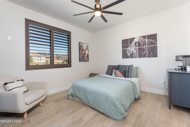 bedroom with ceiling fan and light hardwood / wood-style flooring