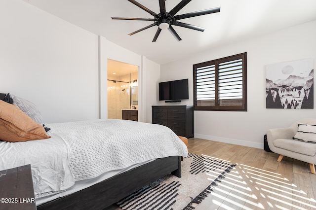 bedroom with connected bathroom, vaulted ceiling, ceiling fan, and light wood-type flooring