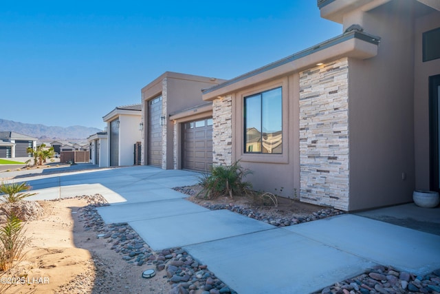 view of side of home featuring a garage and a mountain view