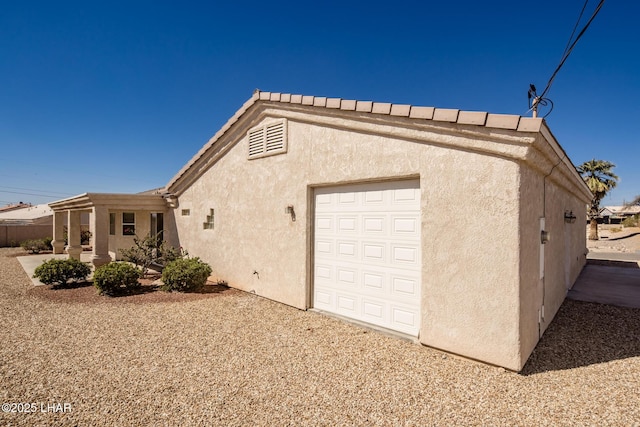 view of property exterior featuring a garage and stucco siding