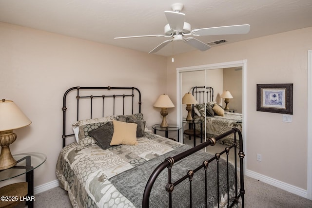 carpeted bedroom featuring a ceiling fan, a closet, visible vents, and baseboards