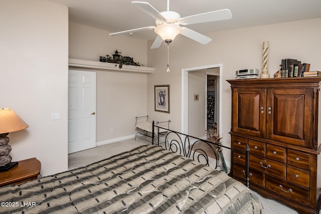 bedroom with light carpet, a ceiling fan, and baseboards