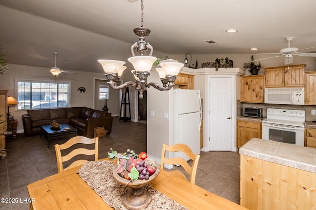 kitchen featuring ceiling fan with notable chandelier, white appliances, tile patterned flooring, and visible vents