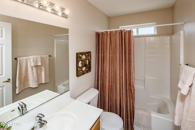 full bathroom featuring shower / bath combo, vanity, and toilet